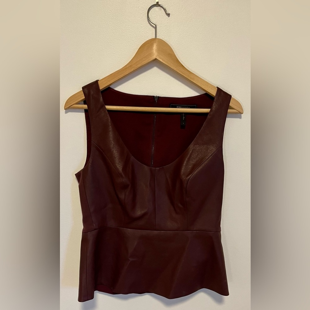 BCBG size 6 sexy sleeveless, flare waisted faux leather top in burgundy red